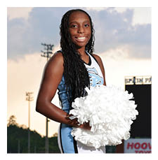 A woman in a cheerleading outfit holding a white pom pom. AI generated content