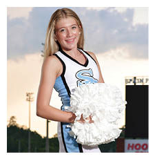 A cheerleader in a blue and white uniform holds a white pom pom. AI generated content