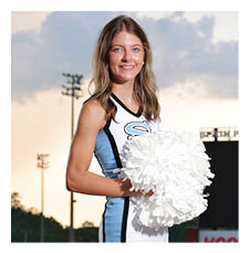 A cheerleader in a blue and white uniform holds a white pom pom. AI generated content