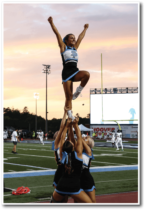 A group of cheerleaders are performing a stunt on the field. AI generated content
