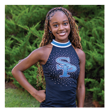 A young woman wearing a black and blue cheerleading outfit stands in a grassy field. AI generated content