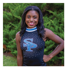 A young girl wearing a cheerleading outfit and a blue bow. AI generated content