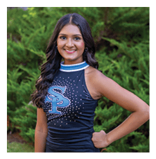 A woman in a cheerleading outfit poses for a picture. AI generated content