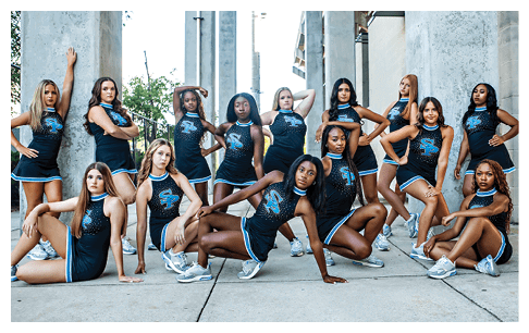 A group of cheerleaders pose for a picture in front of a stadium. AI generated content
