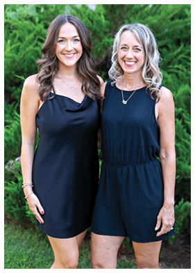 Two women in black dresses and shorts pose for a picture. AI generated content