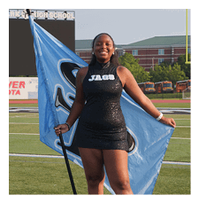 A woman in a black and blue dress holds a flag on a field. AI generated content
