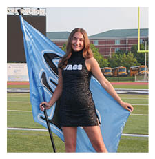 A woman in a black dress stands on a football field holding a blue flag. AI generated content