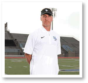 A man wearing a white shirt and a blue hat stands on a football field. AI generated content