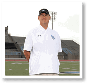 A man wearing a white shirt and black hat stands on a field. AI generated content