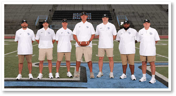 A group of men in white shirts and shorts pose for a picture on a football field. AI generated content