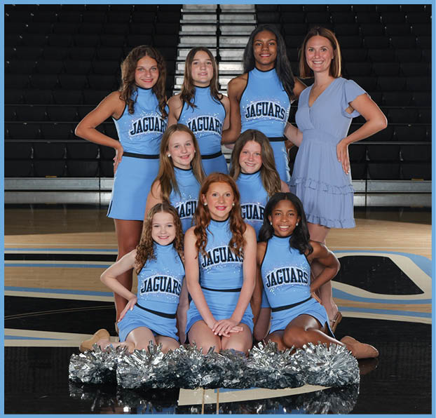 A group of cheerleaders in blue and white uniforms pose for a picture. AI generated content