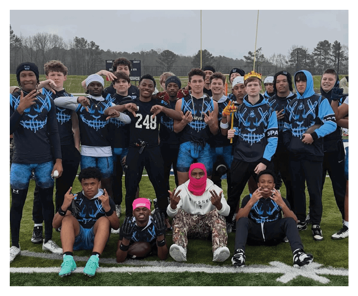 A group of young men wearing football uniforms pose for a photo on a field. AI generated content