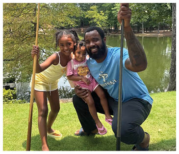 A man, a girl, and a baby pose for a picture. AI generated content