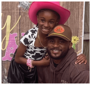 A man and a girl pose for a picture. The girl is wearing a pink cowboy hat and the man is wearing a brown hat. AI generated content