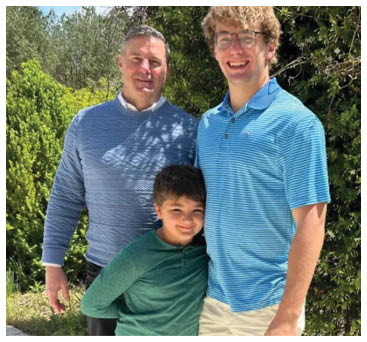 A man and a boy pose for a picture together. AI generated content