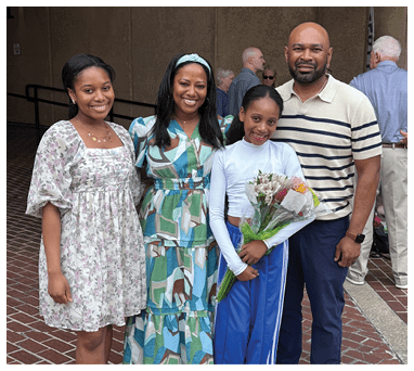 A family poses for a picture in front of a building. AI generated content