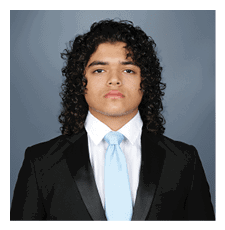A man wearing a suit and tie stands in front of a blue background. AI generated content