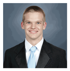 A young man wearing a suit and tie is smiling for the camera. AI generated content