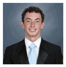 A young man wearing a suit and tie is smiling for the camera. AI generated content