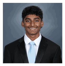 A young man wearing a suit and tie is smiling for the camera. AI generated content