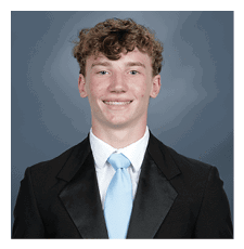 A young man wearing a suit and tie is smiling for the camera. AI generated content