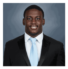 A young man wearing a suit and tie is smiling for the camera. AI generated content
