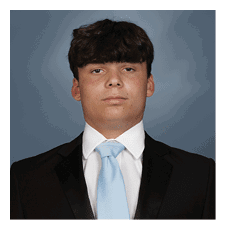 A young man wearing a suit and tie is posing for a picture. AI generated content