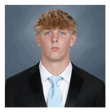 A young man wearing a suit and tie poses for a picture. AI generated content