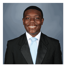 A young man wearing a suit and tie is smiling for the camera. AI generated content