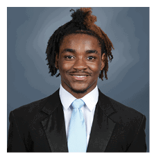 A young man wearing a suit and tie is smiling for the camera. AI generated content