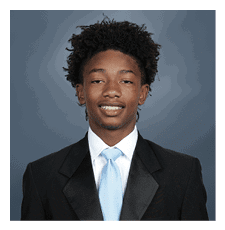 A young man wearing a suit and tie is smiling for the camera. AI generated content