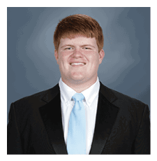 A man wearing a suit and tie is smiling for the camera. AI generated content