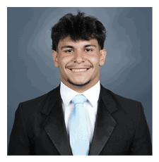 A young man wearing a suit and tie is smiling for the camera. AI generated content