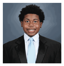 A young man wearing a suit and tie is smiling for the camera. AI generated content