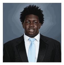 A man wearing a suit and tie is smiling for the camera. AI generated content