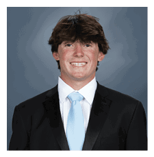 A young man wearing a suit and tie is smiling for the camera. AI generated content