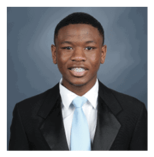 A young man wearing a suit and tie is smiling for the camera. AI generated content