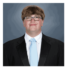 A young man wearing a suit and tie is smiling for the camera. AI generated content
