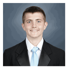 A young man wearing a suit and tie is smiling for the camera. AI generated content