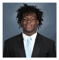 A young man wearing a suit and tie is smiling for the camera. AI generated content