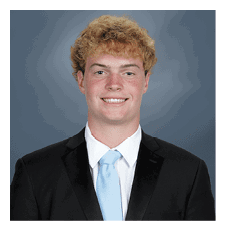 A young man wearing a suit and tie is smiling for the camera. AI generated content