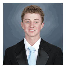 A young man wearing a suit and tie is smiling for the camera. AI generated content