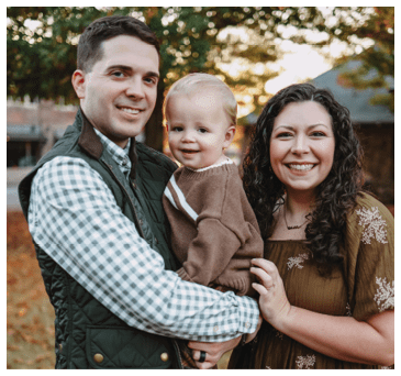A man and woman are holding a baby in their arms. AI generated content