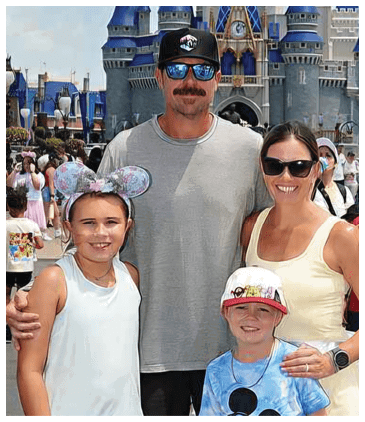 A man, woman, and two children pose for a picture in front of a castle. AI generated content