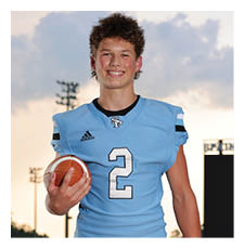 A young man in a blue football uniform is holding a football. AI generated content
