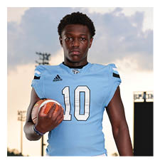 A football player in a blue and white uniform holding a football. AI generated content