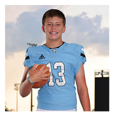 A young man in a football uniform is holding a football. AI generated content