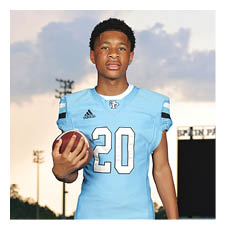 A young man wearing a football jersey with the number 20 on it is holding a football. AI generated content