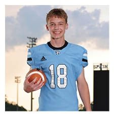 A young man wearing a football uniform and holding a football. AI generated content