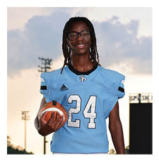 A young man wearing a football uniform and holding a football. AI generated content
